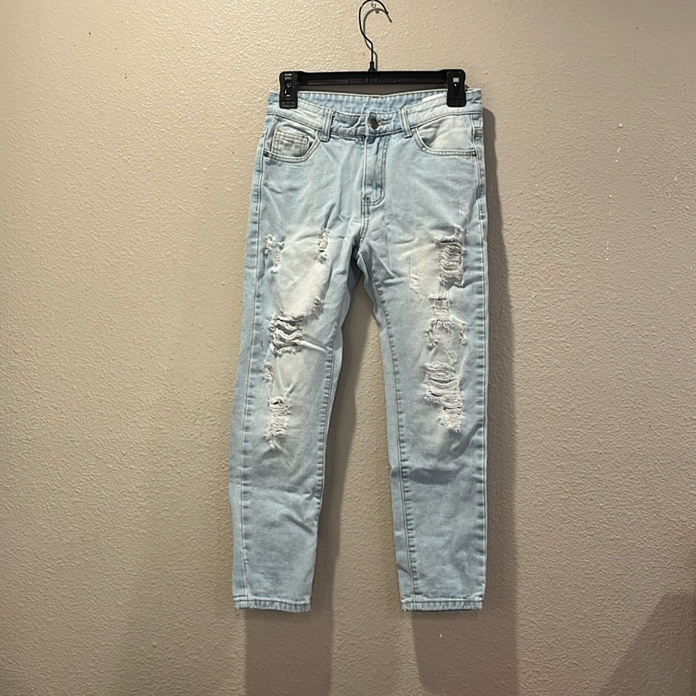 Skinny, ripped style, distressed blue jeans for kids around 11-13